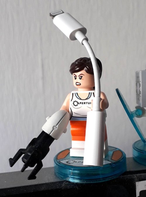 Chell from Portal is keeping an eye on my iPhone headset-adapter